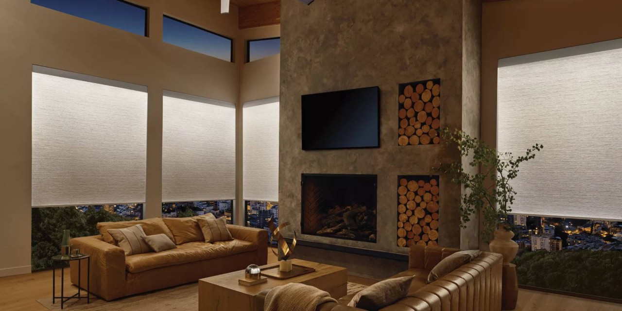 A luxurious apartment’s living room outfitted with Hunter Douglas Aura™ Illuminated Shades