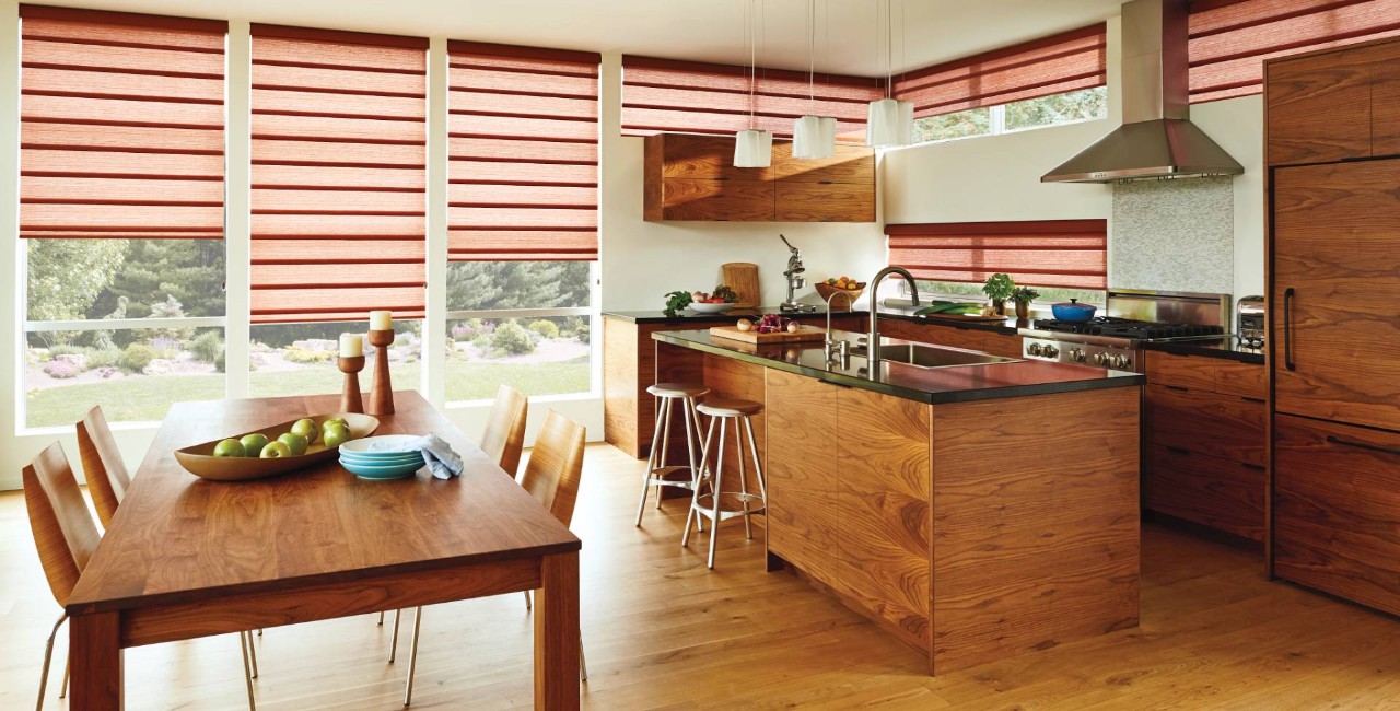 Kitchen with many wooden features and Hunter Douglas Vignette® Roman Shades on the windows at Creative Window Designs near Costa Mesa, CA